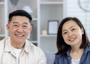 Smiling couple looking right straight out